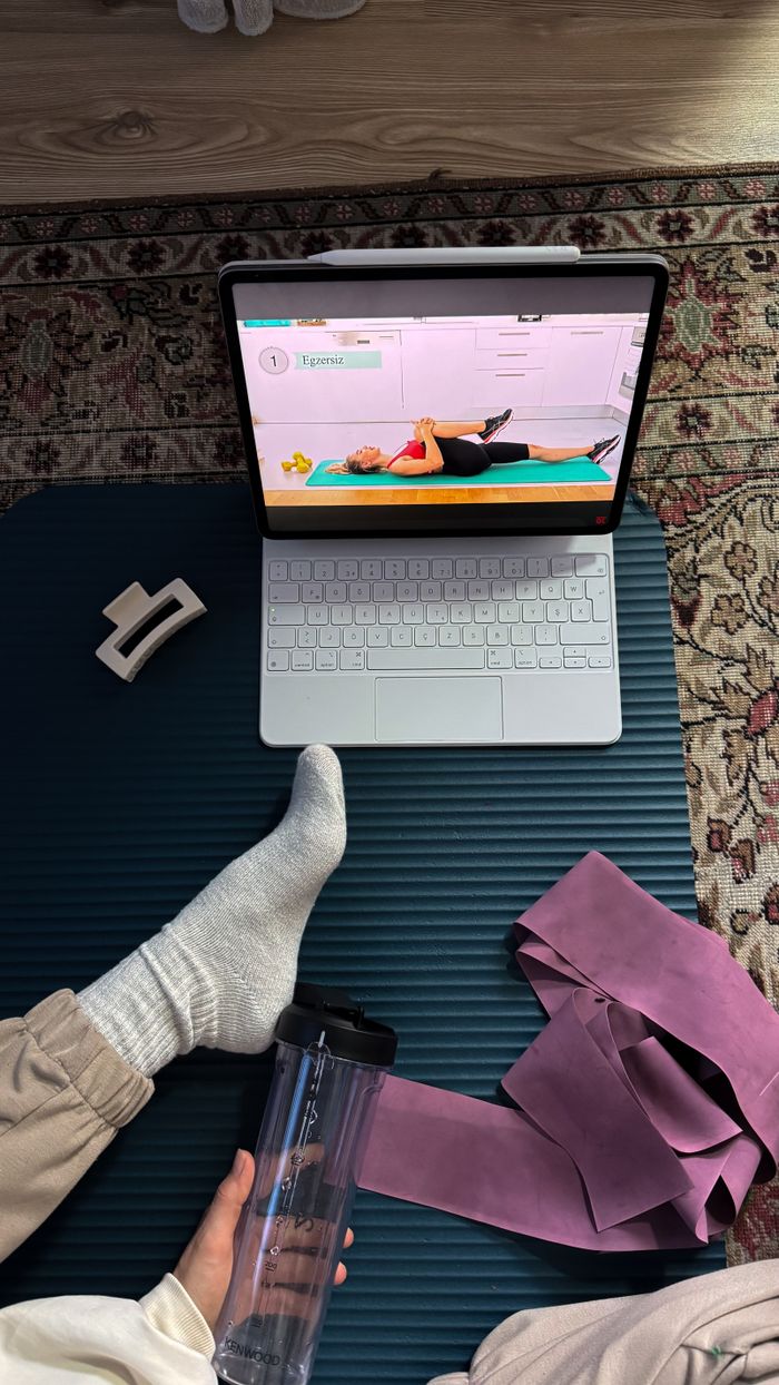 Services A home exercise setup with online fitness class on a laptop. Perfect for remote fitness enthusiasts.